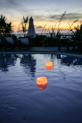 Posada del Faro pool candles at dusk
